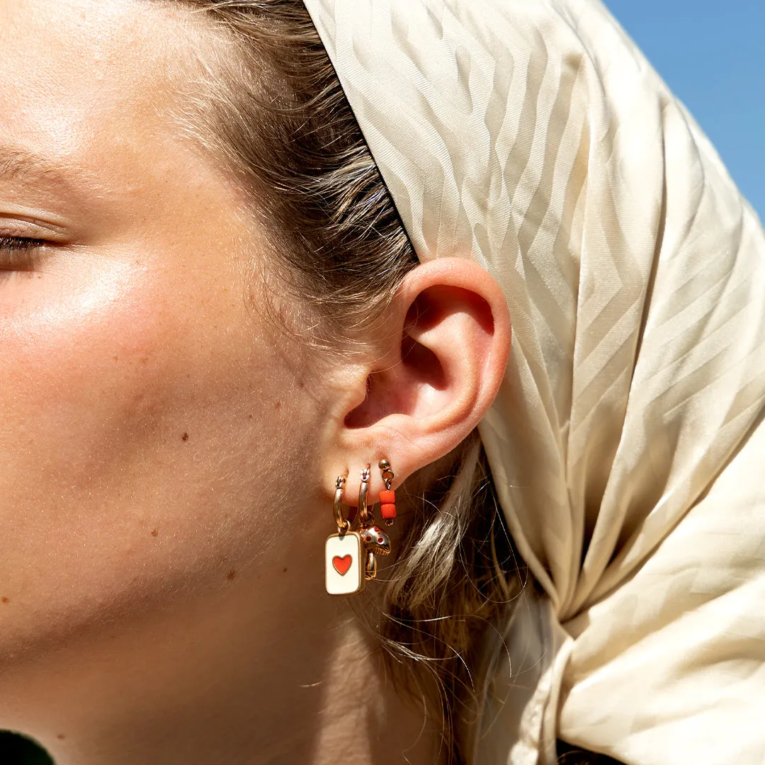 Rose gold coloured/red stud earrings with red beads