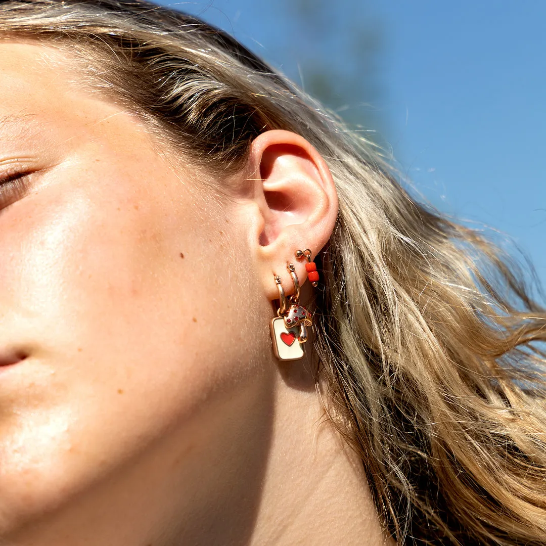 Rose gold coloured/red stud earrings with red beads